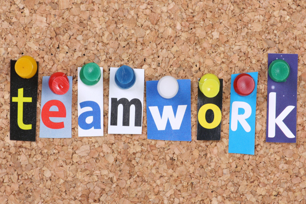 Teamwork in cut out magazine letters
